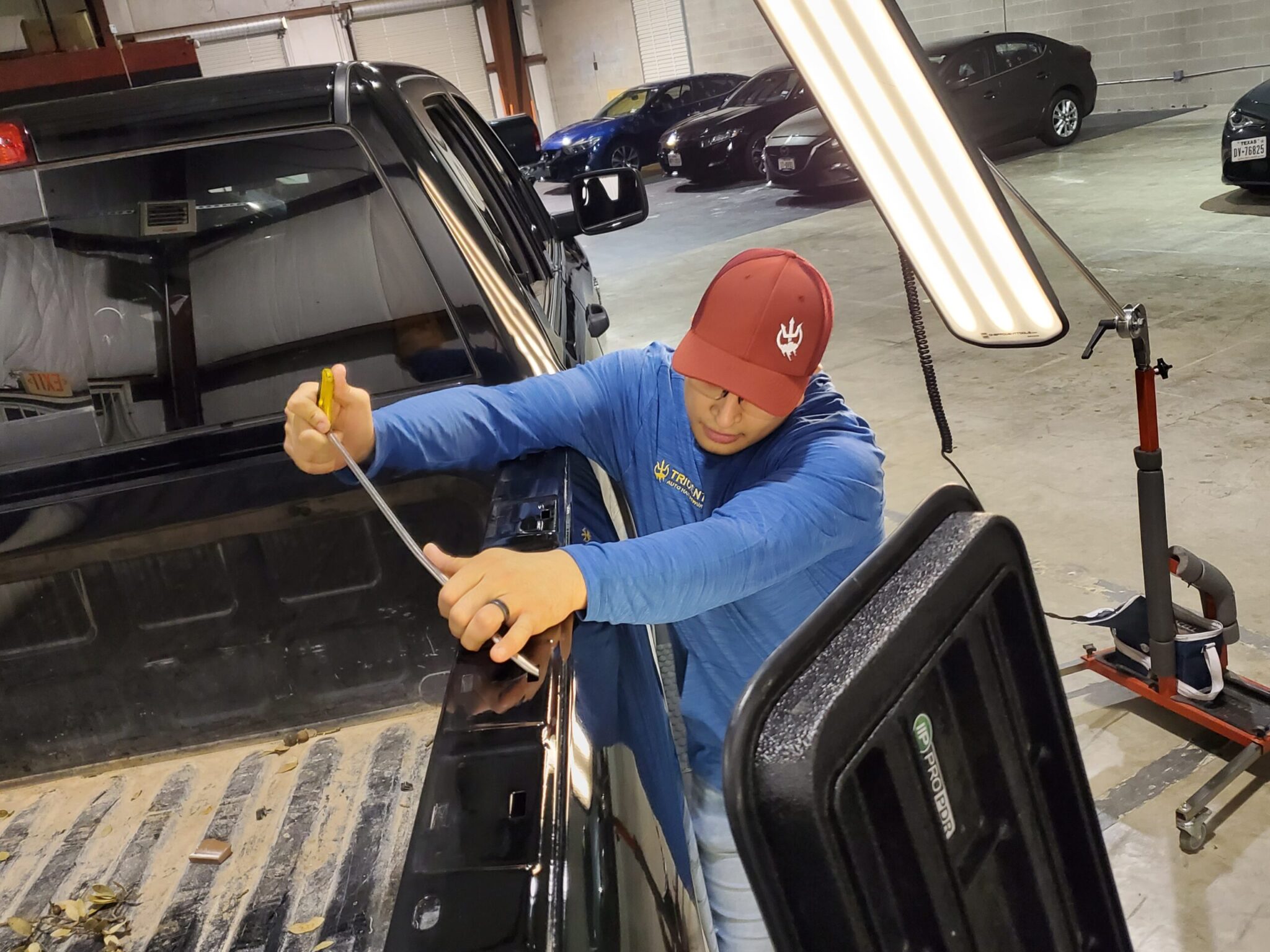 Technician repairing a bedside at the Killeen hail shop