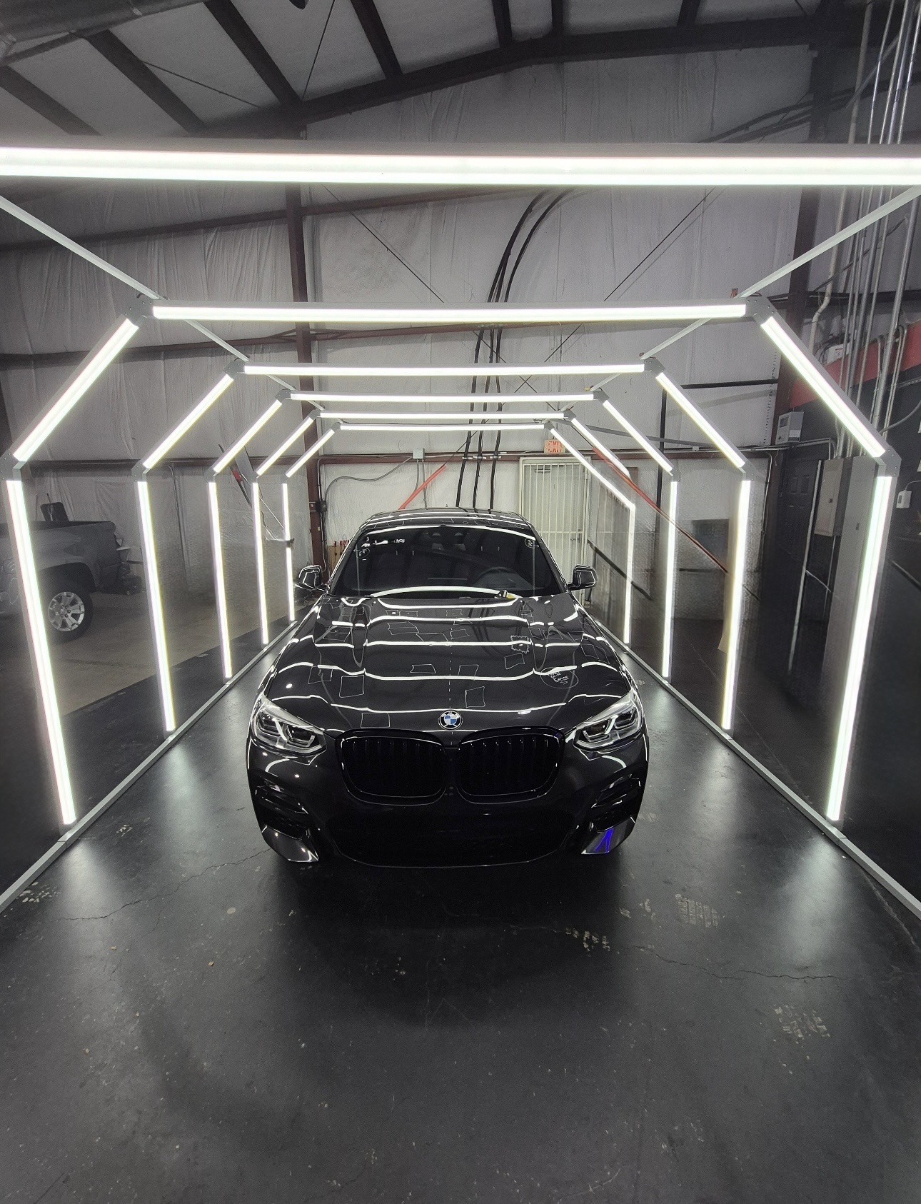 Vehicle in the light tunnel for hail dent inspection